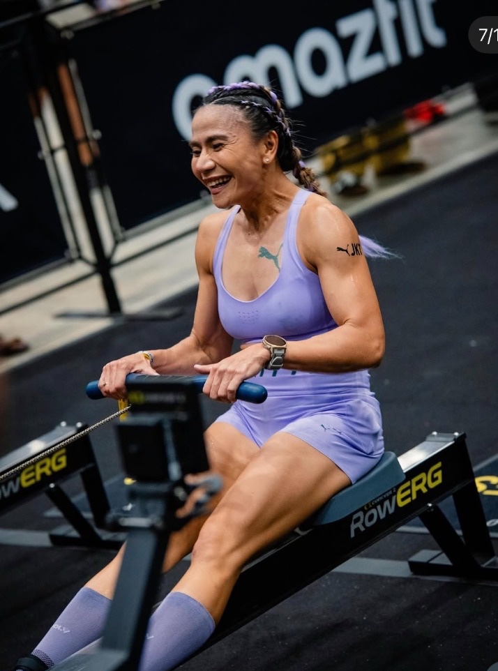 Dina mid-pull on the RowErg, side view