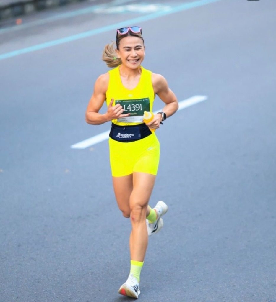 Dina running a Hyrox lap in race kit