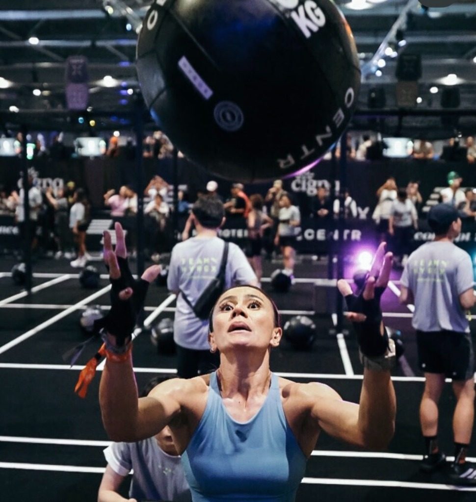 Dina mid wall-ball rep at a Hyrox race